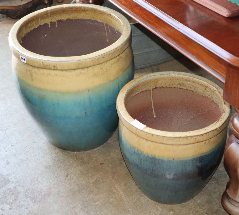 A graduated pair of glazed ceramic garden planters, largest W.48cm, H.51cm